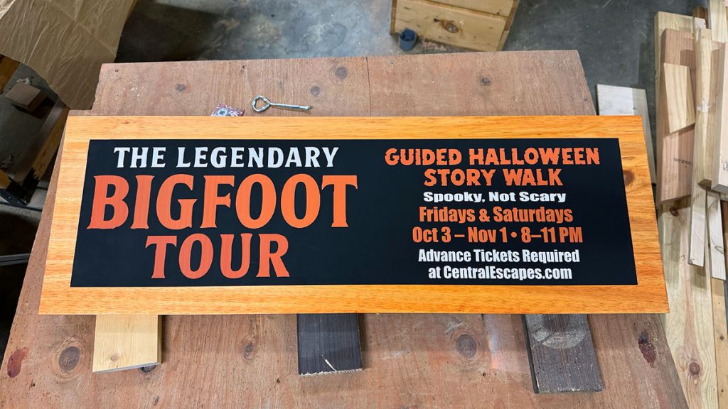 A wooden sign for The Legendary Bigfoot Tour.