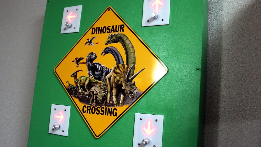 Dinosaur-themed puzzle with lighted directional arrows.